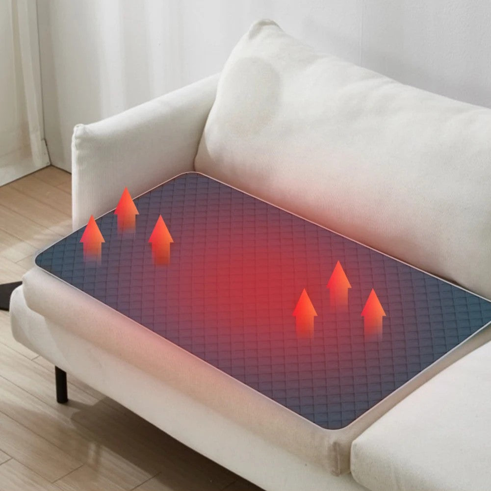 Heated seat pad warming a sofa